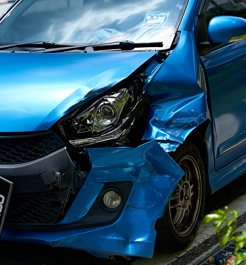 blue car showing damage from accident