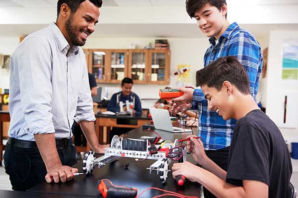 Diverse educator and students in STEM class