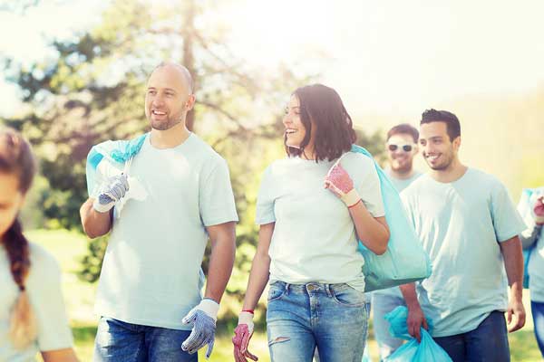 Diverse adult volunteers outside