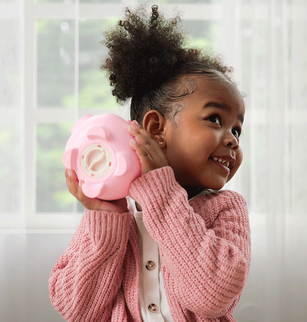 African American girl with pink piggy bank